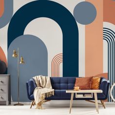 a living room with an abstract wallpaper and blue couch in front of a coffee table