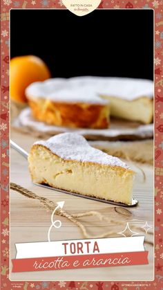 a piece of cake sitting on top of a wooden table next to an orange slice