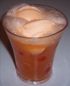 a glass filled with ice cream sitting on top of a table