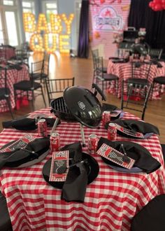 a red and white checkered table cloth topped with black plates