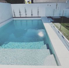 an empty swimming pool with clear blue water