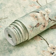 a roll of wall paper with flowers on it