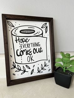 a potted plant sitting next to a sign that says hope everything comes out of it