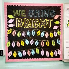 a bulletin board that says we shine bright and decorated with colorful paper eggs on it