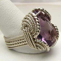 "Wire Wrapped Sterling Silver Handmade Genuine Faceted Amethyst Ring 25x18mm 12+ct View more Amethyst jewelry in our shop https://www.etsy.com/shop/JandSGems?ref=hdr_shop_menu&search_query=amethyst Sizing and shipping is ALWAYS FREE with a 14 day \"No Questions Asked\" return policy. This ring is made with real gems. I made it myself, so if you see a setting you like and want a different gem in it, I can put in another one as they are not finished. I can probably do it for the same price or Exquisite Silver Amethyst Gemstone Ring, Exquisite Silver Amethyst Ring, Elegant Silver Wire-wrapped Crystal Ring, Elegant Silver Wire Wrapped Crystal Ring, Handmade Elegant Amethyst Crystal Ring, Elegant Wire Wrapped Crystal Ring For Anniversary, Elegant Wire Wrapped Crystal Ring For Wedding, Handmade Elegant Purple Crystal Ring, Elegant Purple Crystal Ring For Jewelry Making