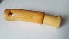 a wooden handle on a white surface