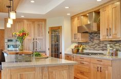 a large kitchen with wooden cabinets and stainless steel appliances