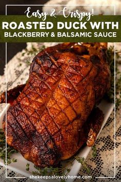 roasted duck with blackberry and balsamic sauce on a white platter, text overlay reads easy & crispy roasted duck with blackberry and balsamian sauce