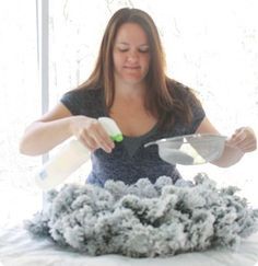 a woman is using a spray bottle to clean the fur off of her bed and make it look like she's falling asleep