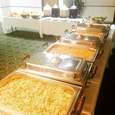 a buffet table filled with lots of different types of food on it's trays