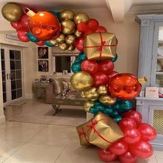 a bunch of balloons that are in the shape of a number with presents on them