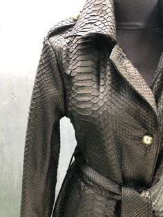 The BLACK SNAKESKIN LEATHER COAT is one of the jewels of the outerwear collection. ⠀ A coat of laconic design with a unique texture of snakeskin and with a magical shade - truly ROYAL LUXURY. This model was created for women who know how to emphasize nobility and impeccable taste with their style. In a python skin coat your every look will be ARISTOCRATIC and, at the same time, trendy. ⠀ We believe our coat will become one of the favorite items in your wardrobe! Outside: Genuine python leather I Luxury Black Leather Long Coat-style Jacket, Coat Elegant, Black Leather Coat, Leather Waist Bag, Python Skin, Long Coat Women, Leather Trench, Nice Leather, Leather Coat