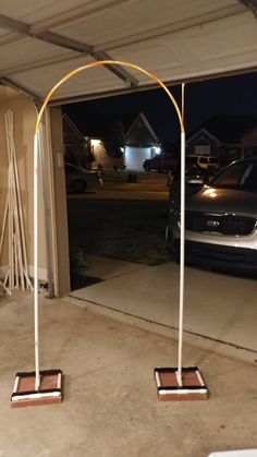 two white poles are standing in front of a car