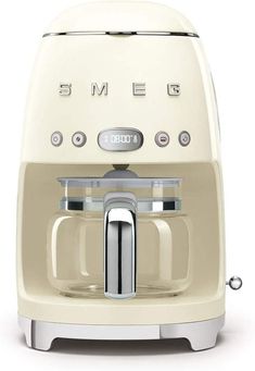 a cream colored coffee maker with the word smeg on it's front panel