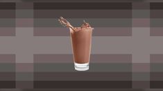 chocolate milkshake in a tall glass on a checkered tablecloth with the liquid being poured into it