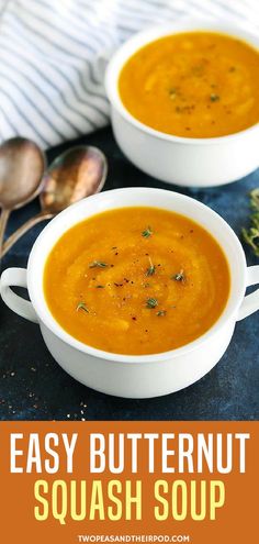 two bowls of easy butternut squash soup on a table with spoons in the background