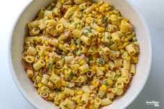 a bowl filled with macaroni and cheese on top of a table