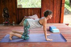 a woman is doing yoga on a mat