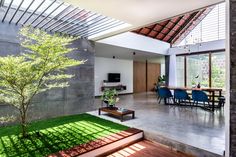 an open living room and dining area with grass on the floor