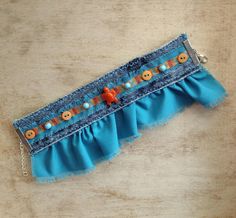 a blue belt with buttons and chains on it