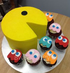 there are cupcakes on the plate with one piece cut out to look like a pacman