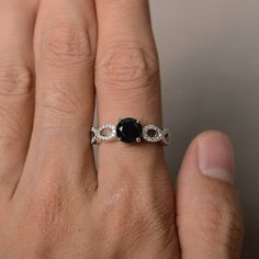 This is a gorgeous handmade creation. Its beauty is its simplicity & Elegance. The 7*7 mm round shape faceted natural Black Spinel is crafted in solid sterling silver and with rhodium plated. Main stone weight about 1.65 ct. cz as accents. All item is sent in a beautiful gift box If you have any idea of design your ring,pls contact me directly. You can realize more lovely stuff clicking the link https://www.etsy.com/shop/knightjewelry?refshopsection_shophome_leftnav Please leave the correct Elegant Ethical Sapphire Promise Ring, Diamond Cut Sapphire Ring, Diamond Cut Round Sapphire Ring, Sapphire Ring With Diamond Cut, Black Sapphire Fine Jewelry Ring, Elegant Black Spinel Jewelry With Prong Setting, Elegant Black Spinel Diamond Ring As Gift, Round Sapphire Ring With Diamond Cut For Promise, Elegant Round Sapphire Ring