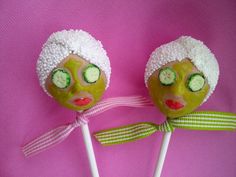 two green dolls with white hair are holding forks and spoons on a purple background