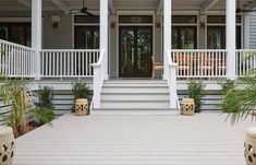 the front porch of a house with two planters