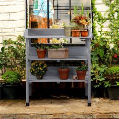 potted plants are sitting on top of a shelf