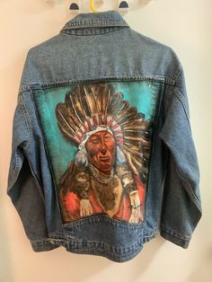 Vintage 1980’s Levis Jean Jacket Steve Harris Painting Rare One Of One Original. Here I have an original Steve Harris painting of a Indian tribe man with lots of color and detail, truly a one of a kind piece. This painting on the jacket was purchase from a lady that use to date the man himself, jacket does have some stain here and there from over the year of not washing the jacket due to the painting. Jacket size is an XL, from top to bottom the length of the jacket is 28 inches and from pit to Retro Winter Outerwear With Graphic Print, 90s Graphic Print Outerwear For Fall, 90s Style Graphic Print Outerwear For Fall, 90s Long Sleeve Denim Jacket For Winter, American Retro Long Sleeve Outerwear For Fall, Vintage Outerwear With Graphic Print For Streetwear, Vintage Winter Outerwear With Graphic Print, Vintage Long Sleeve Outerwear With Graphic Print, Vintage Denim Jacket With Graphic Print