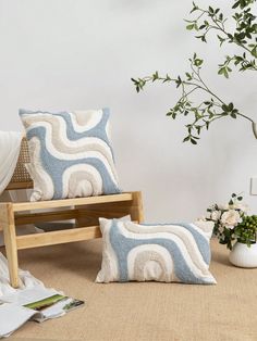 two pillows sitting on top of a rug next to a chair