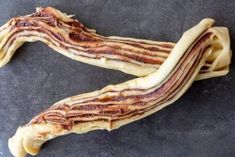 two pieces of bacon sitting on top of a table