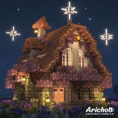 a house with flowers on the roof and lights in the windows is lit up at night