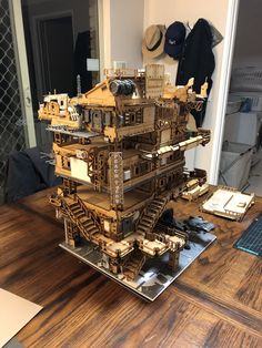 a model of a building on top of a wooden table