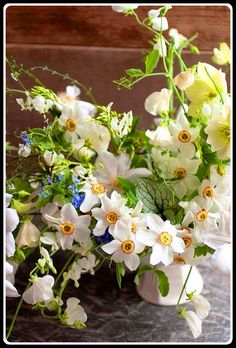 a vase filled with white flowers on top of a table