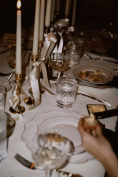 the table is set with silverware and candles