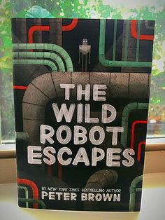 the book cover for the wild robot escapes by peter brown is displayed in front of a window