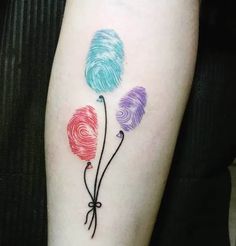 three colorful balloons tattoo on the left arm and leg, one is colored with different colors