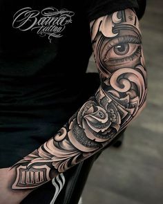 a man with a black and grey tattoo on his arm