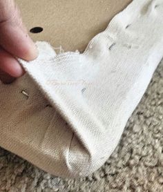 someone is peeling the fabric off of a piece of cloth with their thumbnails