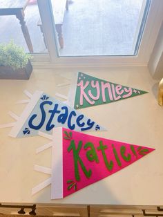 three pennants with the words space, kettleo and kyte on them hanging from a kitchen counter