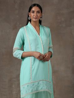 A two piece set comprising of a long soft cotton turquoise blue kurta with crochet details on hemline, the kurta has insertion laces and sleeves has got pintucks details.It is paired with straight cut soft cotton pants adding pintucks details and insert laces to complete the look. Color: Turquoise Blue Fabric Composition: Kurta Set - Soft cotton Note: The product will be delivered within 20-25 days of order placed Care Instruction: Dry Clean Only. Do not use heavy Iron Cotton Kurta Set, Blue Kurta, Cotton Kurta, Color Turquoise, Kurta Set, Crochet Details, Pin Tucks, Cotton Pants, Best Deal