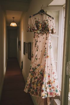 a dress hanging up on a door way