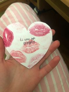 someone is holding a heart shaped paper with lipstick imprints and the words it's almost be sempo written on it