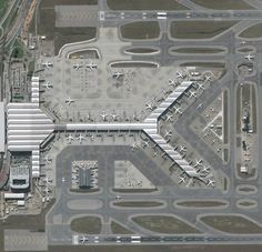 an aerial view of the airport with many planes