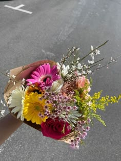 a bouquet of flowers is wrapped in brown paper