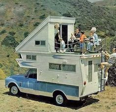 people are standing on the roof of a tiny house