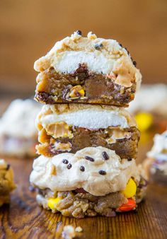 three cookies stacked on top of each other with white frosting and chocolate chips in the middle