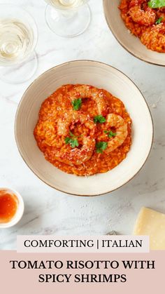 two white bowls filled with shrimp and tomato sauce