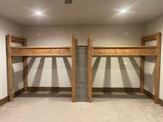 two wooden bunk beds in an empty room